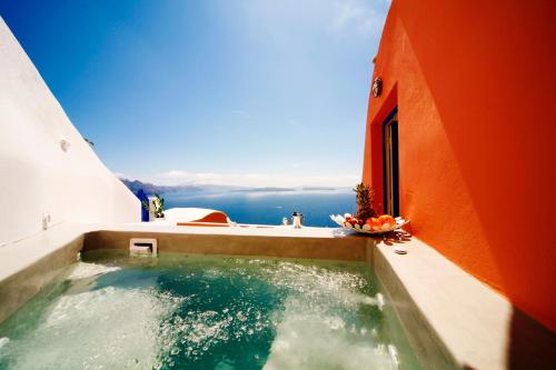 a hot tub on the balcony of a building at Chroma Suites in Oia