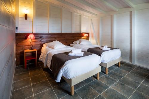 a room with three beds in a room at Le Rayon Vert - Hôtel & Restaurant VUE SUR MER in Deshaies