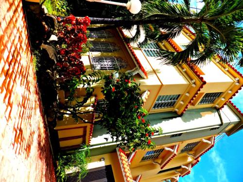 a building with flowers on the side of it at Canario Boutique Hotel in San Juan