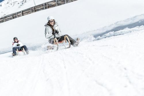 a group of people riding in the snow at Apart Andrea in Längenfeld