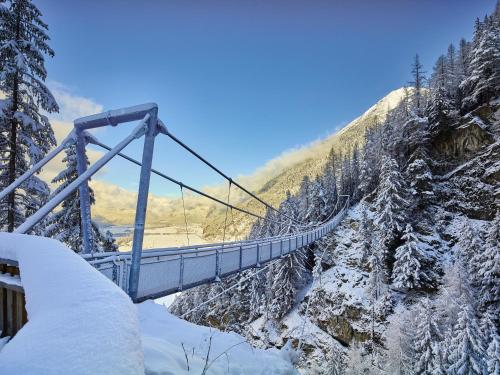 a suspension bridge in the snow on a mountain at Apart Andrea in Längenfeld