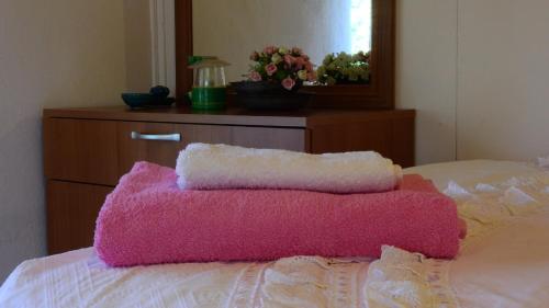 a pink blanket on top of a bed with a dresser at Eren Villa in Sapanca