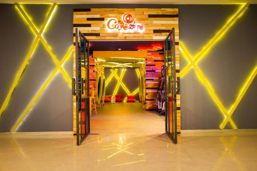 a store hallway with a neon sign on the wall at Dreams Jade Resort & Spa - All Inclusive in Puerto Morelos