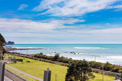 a view of a beach with the ocean at Millennium Hotel New Plymouth, Waterfront in New Plymouth