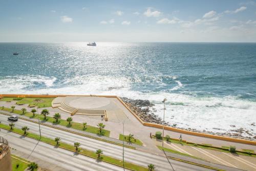 a view of the ocean with a boat in the water at Hotel Diego De Almagro Costanera - Antofagasta in Antofagasta