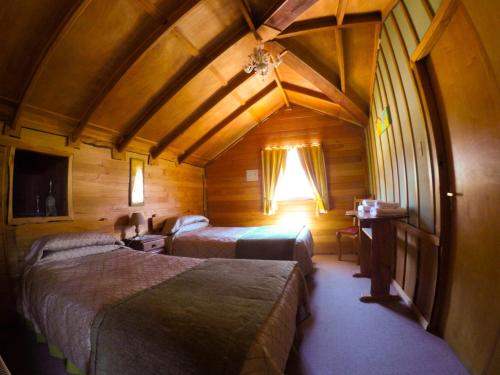 A bed or beds in a room at Hotel Antigua Casona Patagonia