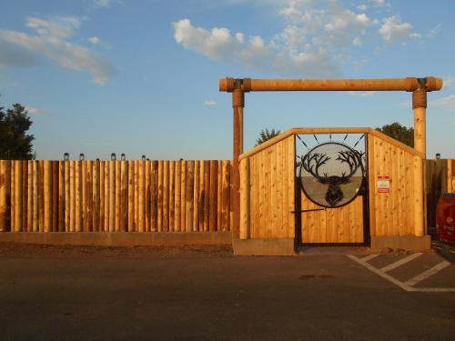 a wooden fence with a gate with a wreath on it at Grand Canyon Inn and Motel - South Rim Entrance in Valle