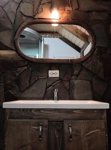 a bathroom with a sink and a mirror at VIGORA in Verkhovyna