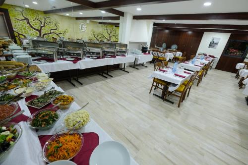 a buffet line with tables and plates of food at Tantur Hills Hotel - Jerusalem in Jerusalem