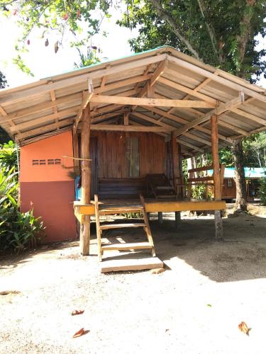a wooden pavilion with a bench and a table at Koh Mak Green View Resort in Ko Mak