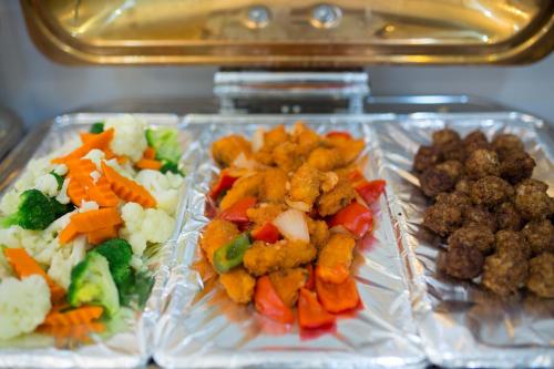 three plastic containers filled with different types of food at Golden Sail Hotel & Spa in Hanoi