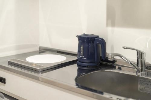 a coffee maker sitting on a counter next to a sink at Kyo no yado en in Kyoto