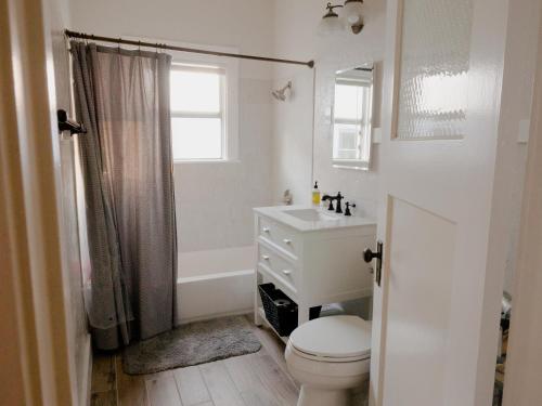 uma casa de banho branca com um WC e um lavatório em Spacious, Sunny House in Berkeley/Oakland Rockridge em Oakland