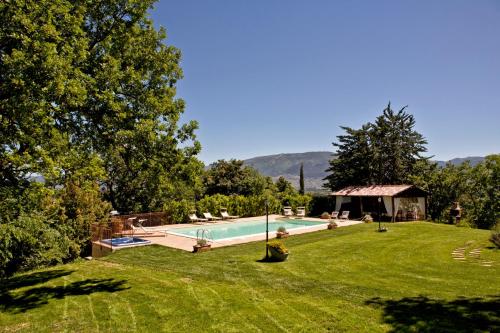 a yard with a swimming pool in the grass at La Tenuta Dei Ricordi in Castel Ritaldi