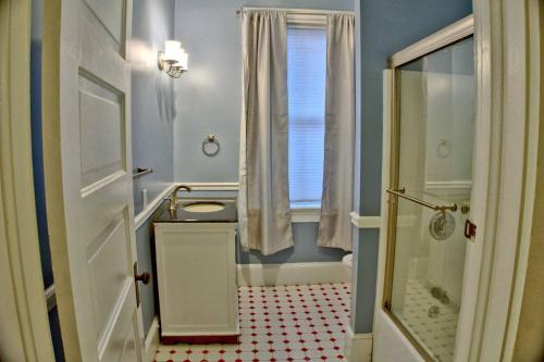 a bathroom with a shower and a sink and a toilet at Beautiful 6 Bed, 5 Bath Historic Savannah Home in Savannah