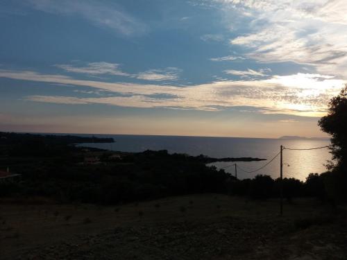 a view of the ocean at sunset at Armiriki Apartments in Korakokhórion