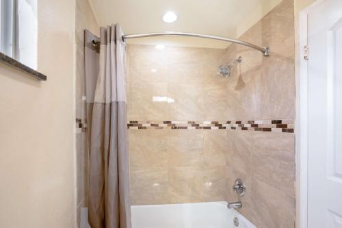a bathroom with a shower with a shower curtain at Motel 6-Odessa, TX - 2nd Street in Odessa