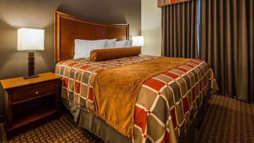 a hotel room with a large bed and a night stand at Best Western Plus Easton Inn & Suites in Easton