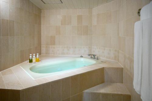 a bathroom with a bath tub with a sink at Rusutsu Resort Hotel & Convention in Rusutsu