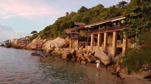 a group of people standing in the water near a river at Tao Thong Villa 1 in Koh Tao
