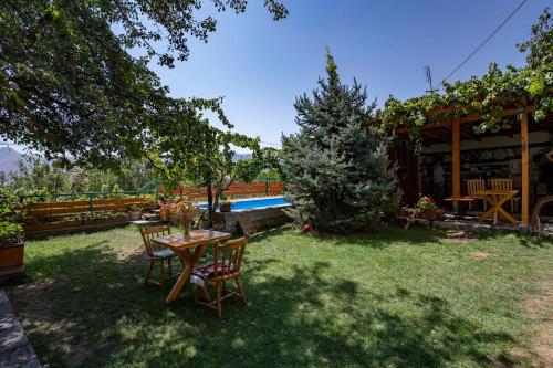 a table and chairs in the yard of a house at Green Stone Boutique Hotel in Yeghegnadzor