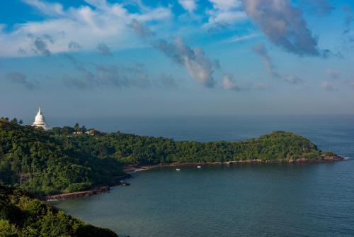 an island with a lighthouse in the middle of a body of water at Agnus Unawatuna in Unawatuna