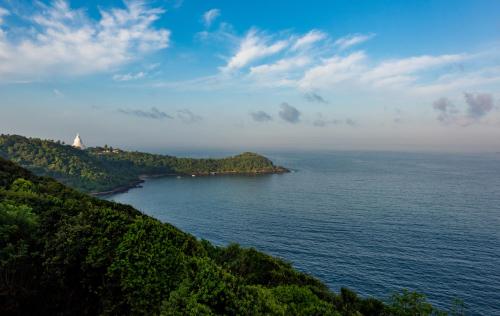 an island in the middle of a body of water at Agnus Unawatuna in Unawatuna