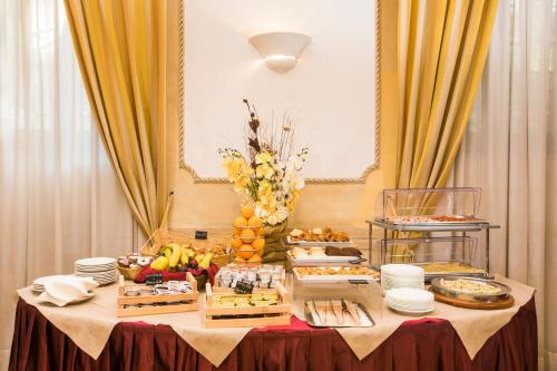 a table with a buffet of food on it at Hotel Villa Rosa in Rome