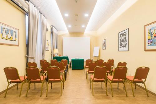 a room with a bunch of chairs and a podium at Hotel Villa Rosa in Rome
