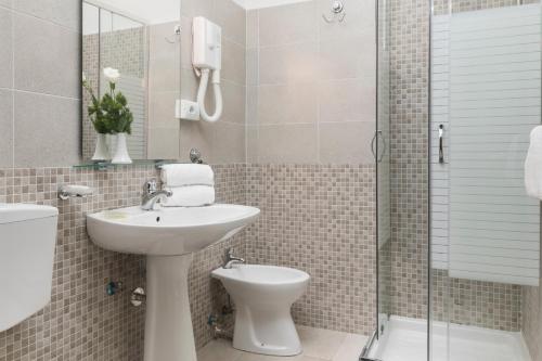 a bathroom with a sink and a toilet and a shower at Hotel Villa Rosa in Rome