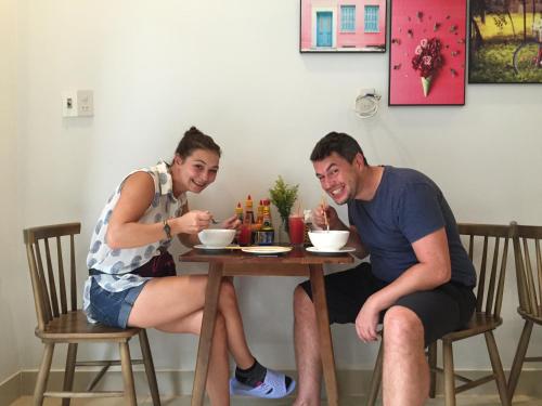 a man and a woman sitting at a table at candyinn in Hue