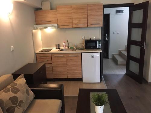 a small kitchen with a white refrigerator in a room at The White Houses Complex in Nesebar