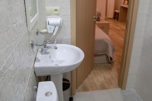 a bathroom with a sink and a toilet at Family Hotel Triston in Tbilisi City