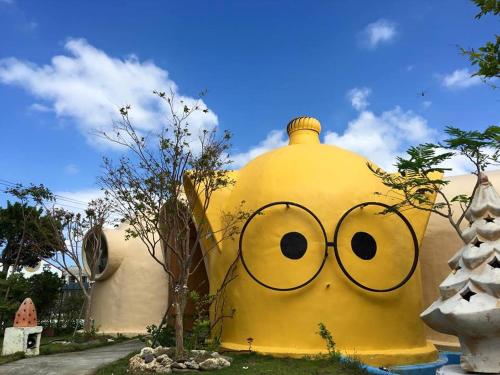 a large yellow building with a face drawn on it at Kenting Ha-Bi Star Fort in Hengchun