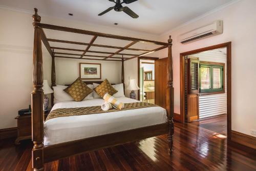 a bedroom with a large bed with a ceiling fan at Cable Beach Club Resort & Spa in Broome