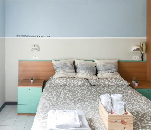 a bedroom with a large bed with a wooden headboard at Alba B&B in Cattolica