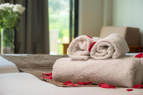 a pile of towels sitting on top of a table at Rodon Hotel and Resort in Agros