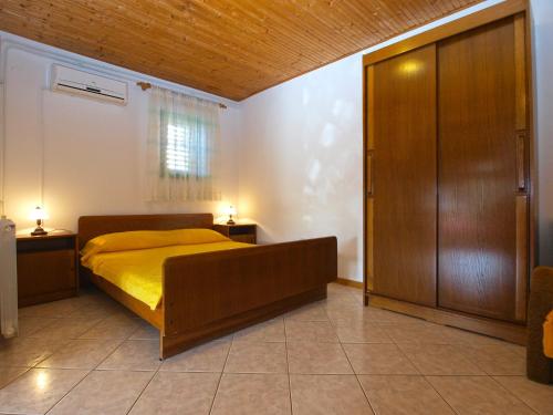 a bedroom with a bed and a wooden door at Apartments Ozren 311 in Fažana