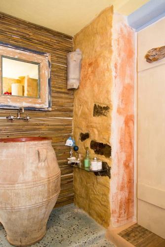 a bathroom with a toilet and a mirror at The Old Pomegranate House in Mirsíni