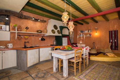 a kitchen with a table and chairs in a room at The Old Pomegranate House in Mirsíni