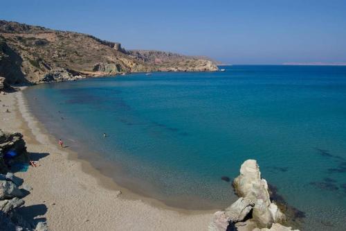 a view of a beach with rocks in the water at The old cheese hut in Zou