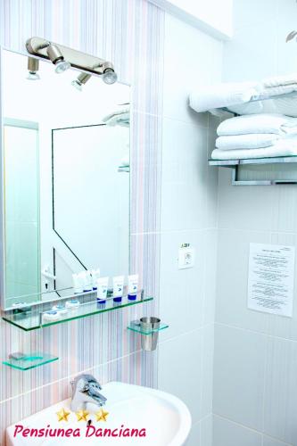 a bathroom with a sink and a mirror at Pension Daciana in Bacău