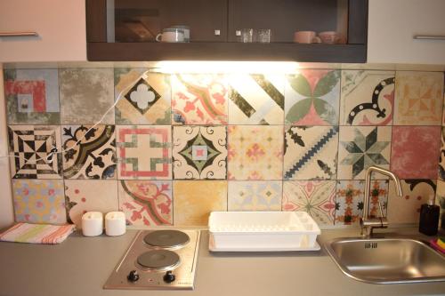a kitchen with a sink and a counter with tiles at Studio apartment LoSt in Ogulin