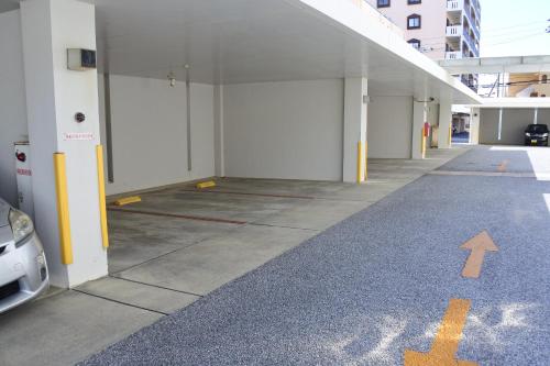 an empty parking garage with a car parked in it at Hotel Sunset Terrace in Chatan