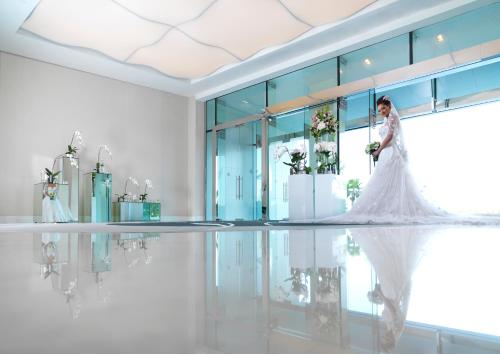 a woman in a wedding dress standing in a room at Fairmont Bab Al Bahr in Abu Dhabi