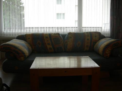 a couch with a coffee table in front of a window at Studio Bündawiese 6 in Davos