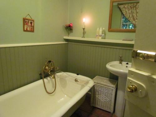 a bathroom with a bath tub and a sink at High Hopes in Greyton
