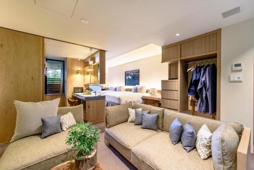 a living room with a couch and a bedroom at Fufu Kawaguchiko in Fujikawaguchiko