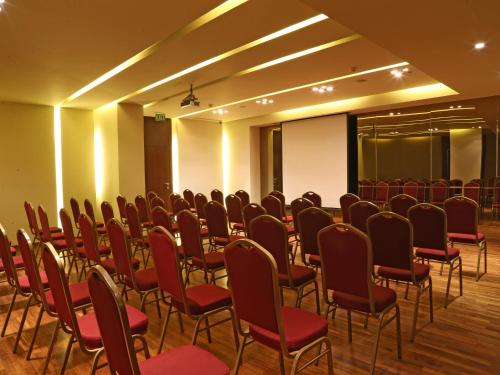 a room with a bunch of chairs in it at Lancaster Suites Raouche in Beirut