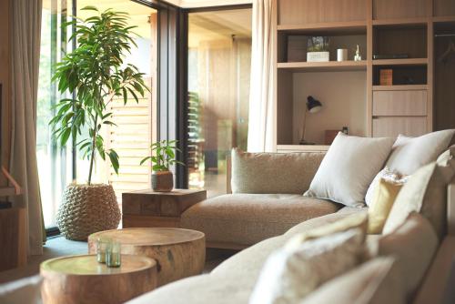 a living room with a couch and a table at Fufu Kawaguchiko in Fujikawaguchiko